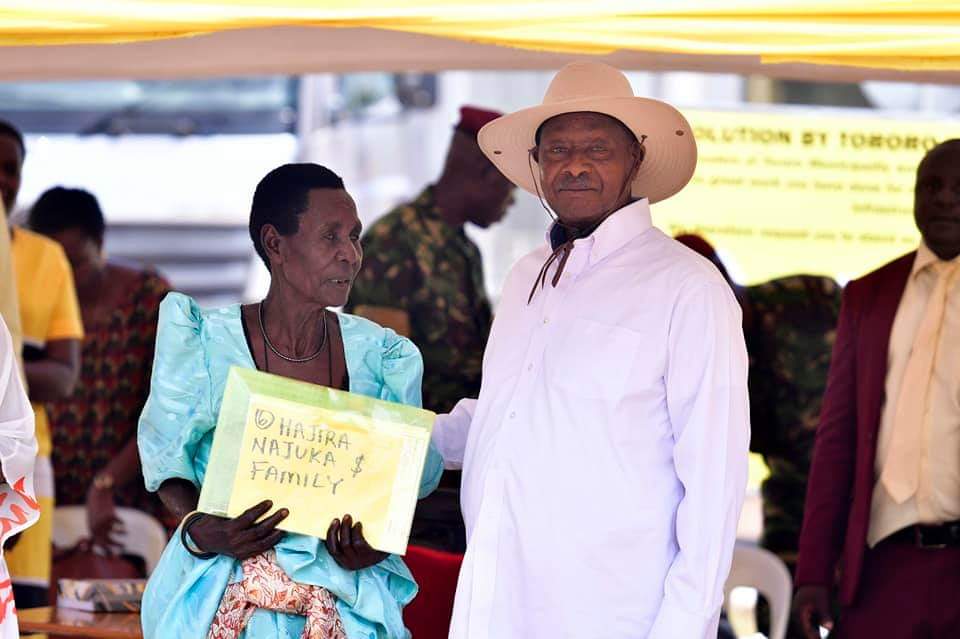 One of the beneficiaries receiving the certificate of customary ownership from the President of Uganda, H.E Yoweri Kaguta Museveni